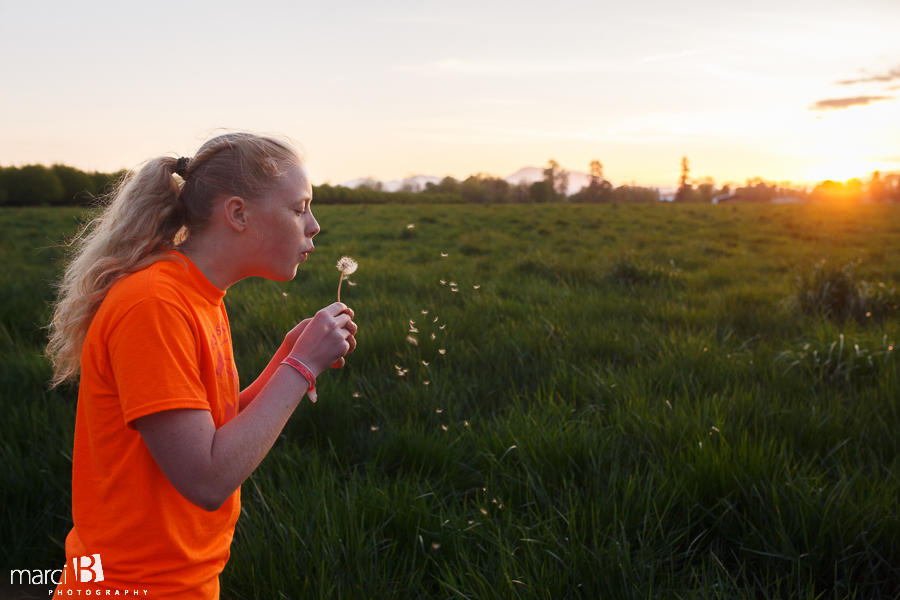 Girl blowing dandelion