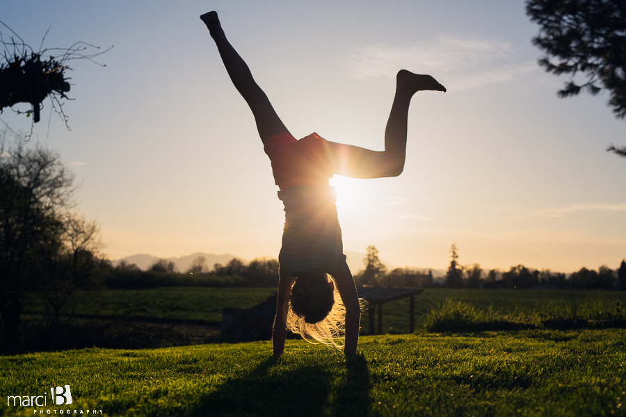 Lifestyle photography - child - cartwheel - silhouette