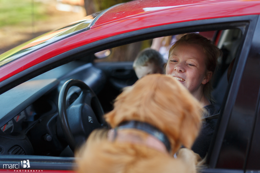 dog welcoming girl home