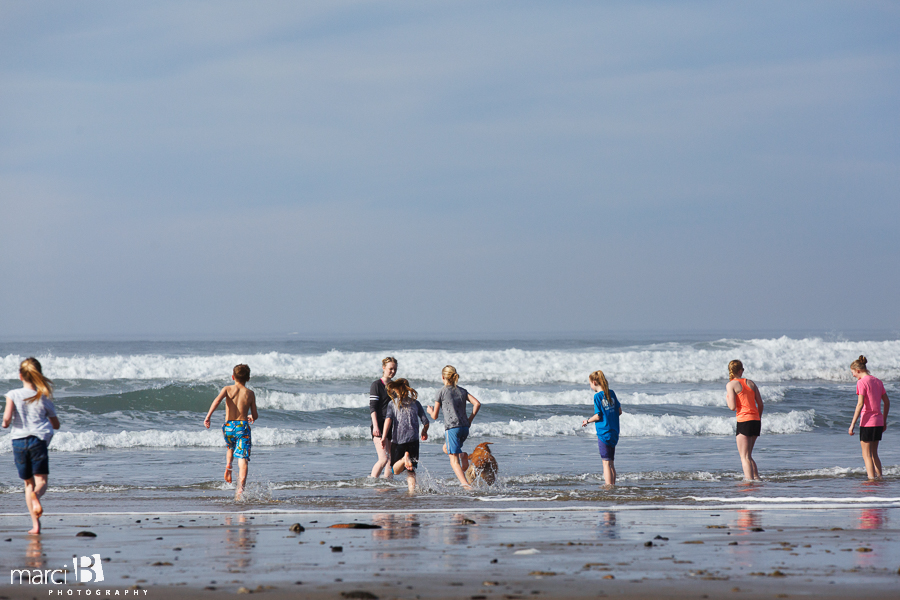 Oregon coast - kids at the beach - running in the waves